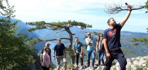 Group of travelers taking selfie with Drina river in the back
