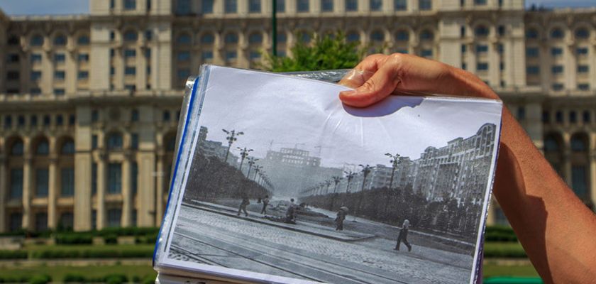 Historic photograph held in front of the Palace of Parliament in Bucharest, Romania