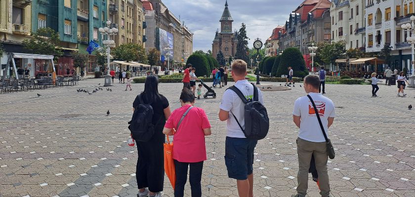 Travelers walking through the historic center of Timișoara, Romania