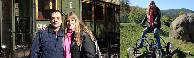 Girl and guy are posing in front of the wagon of sargan eight train