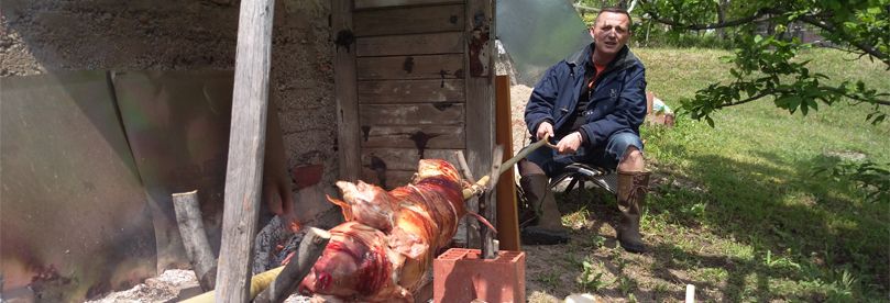 Man is roasting a pork.