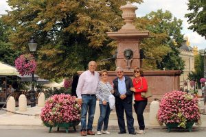 Four people enjoy in Serbia vacation package in front of the fountain in Sremskim Karlovcima.