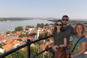 Three guests are posing on Gardoš tower in Zemun.
