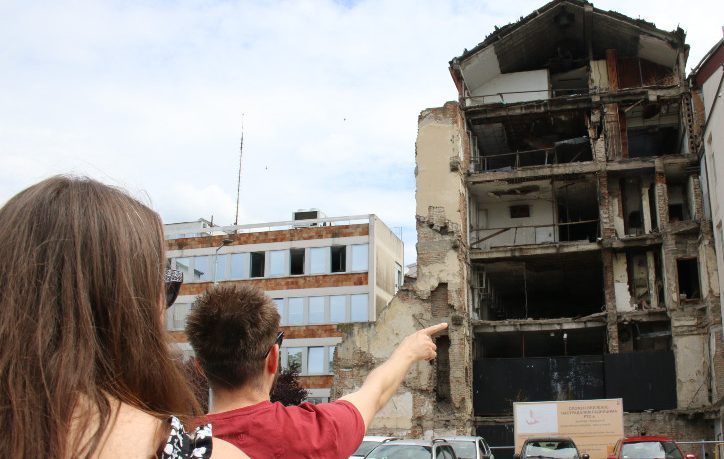 Visitors in front of the bombed RTS building